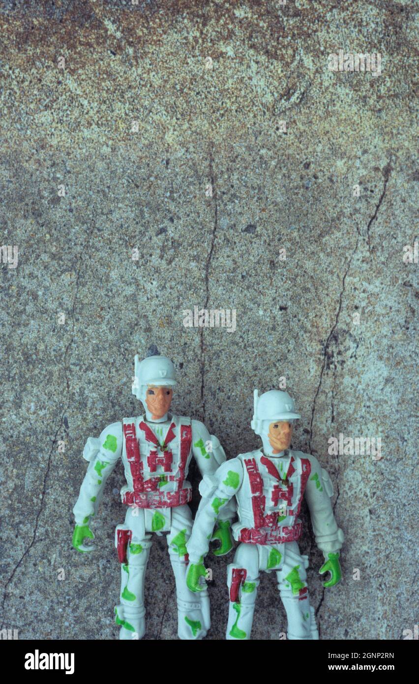Plastic models of two men in action gear standing as if preparing to face enemy Stock Photo