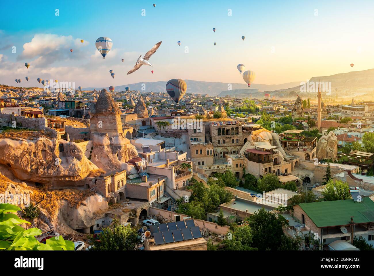 Hot air balloons at sunset in Goreme town, Cappadocia, Turkey Stock Photo