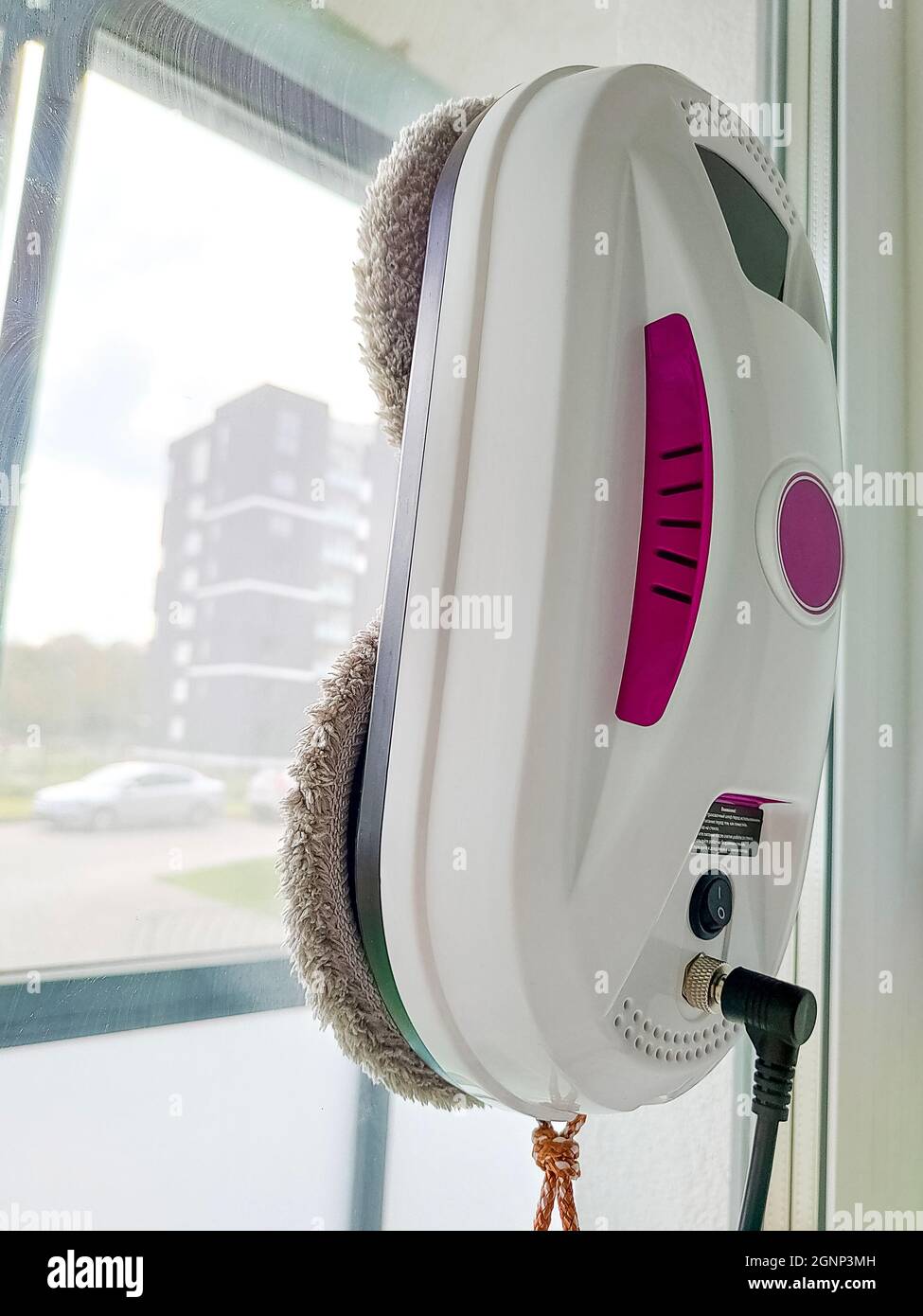 Vacuum cleaner robot washing glass window. Robot window cleaner Stock