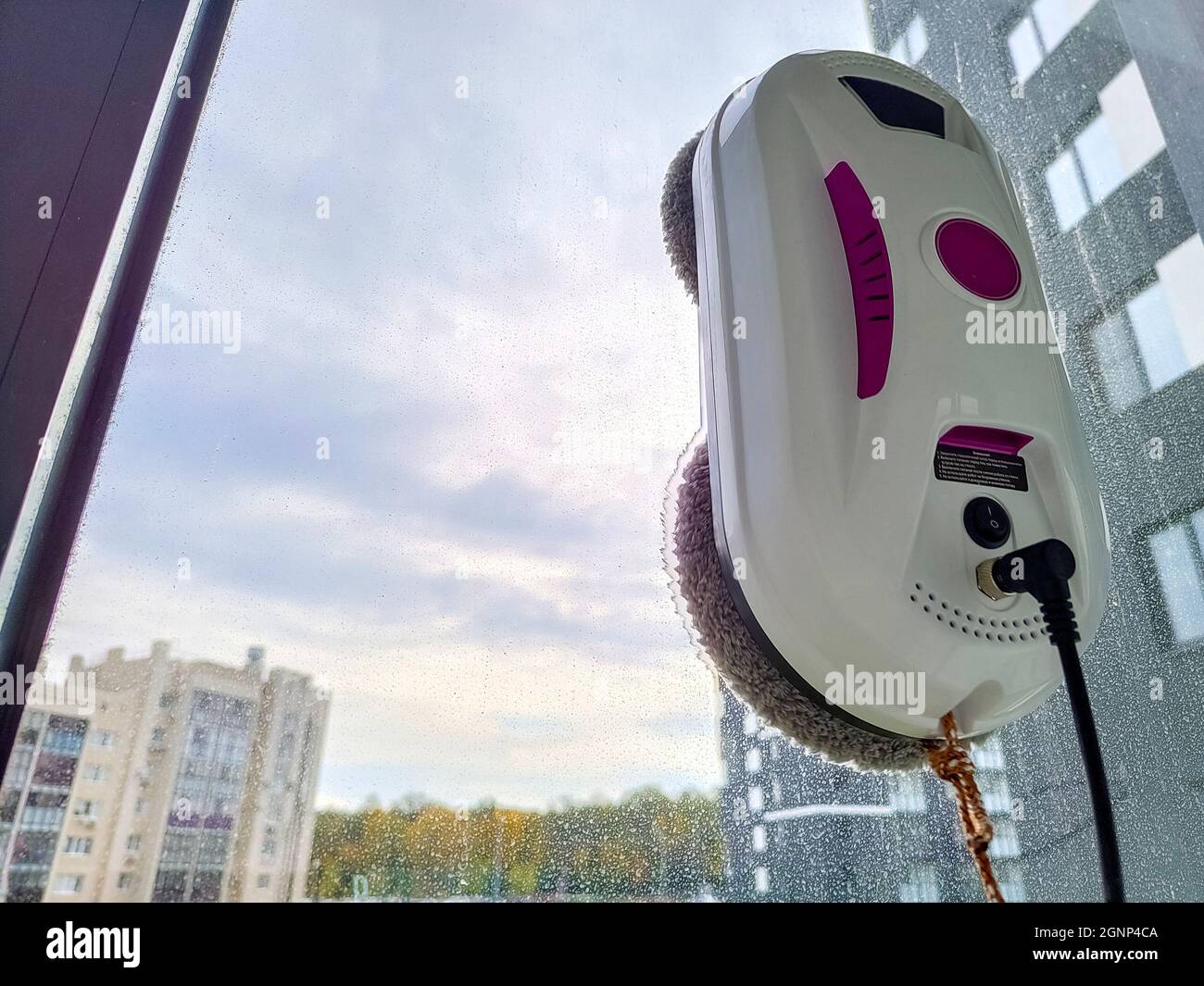 Vacuum cleaner robot washing glass window. Robot window cleaner Stock