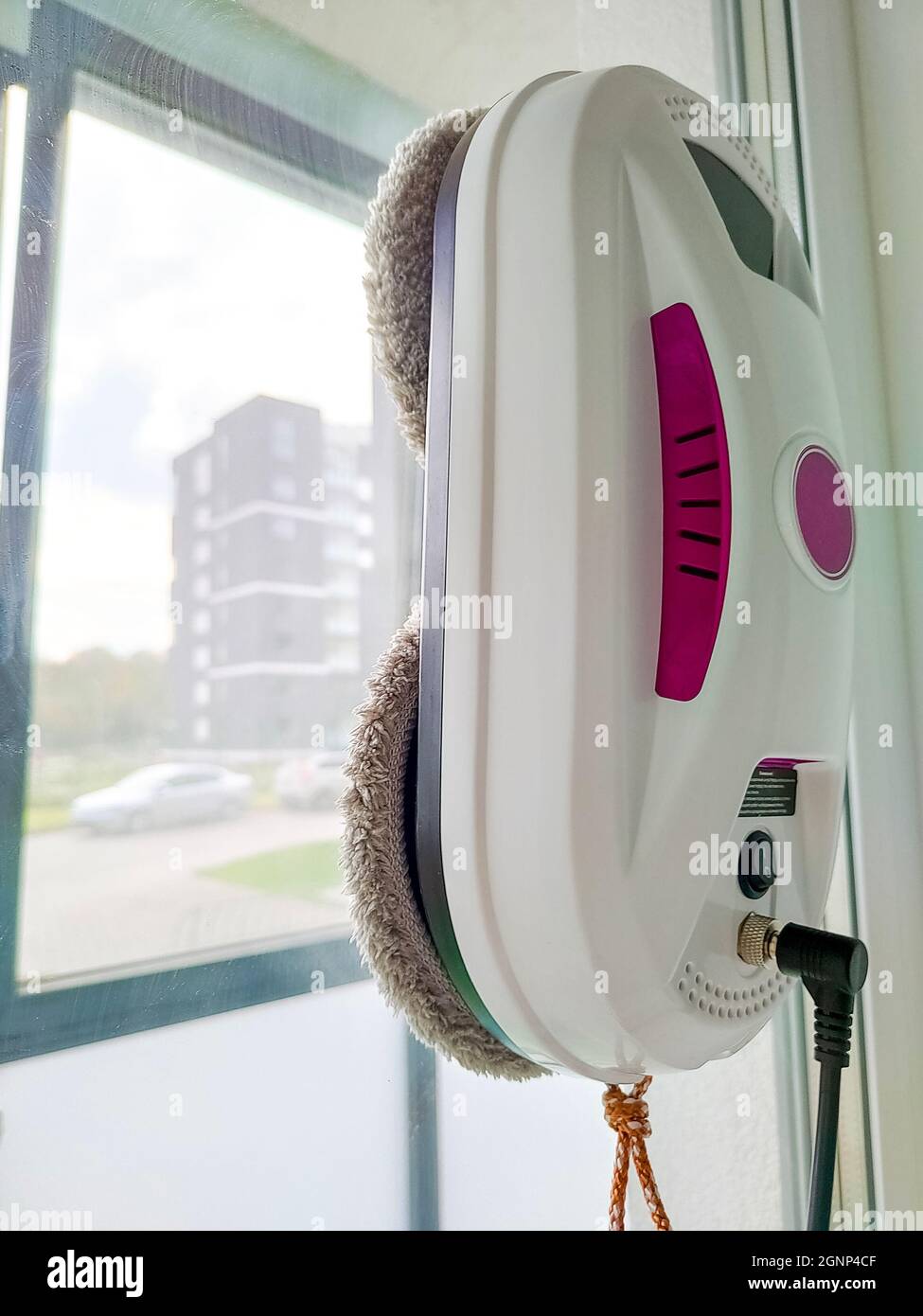 Vacuum cleaner robot washing glass window. Robot window cleaner Stock