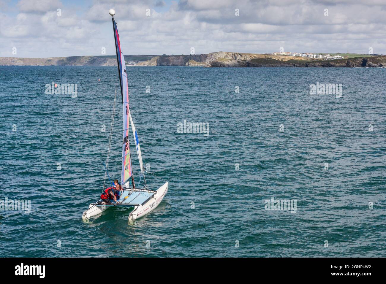 A Hobie Cat catamaran sailing in Newqay Bay in Cornwall. Stock Photo