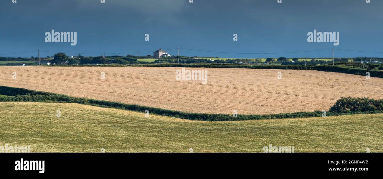 A panoramic image of dark skies over farmland in Newquay in Cornwall. Stock Photo