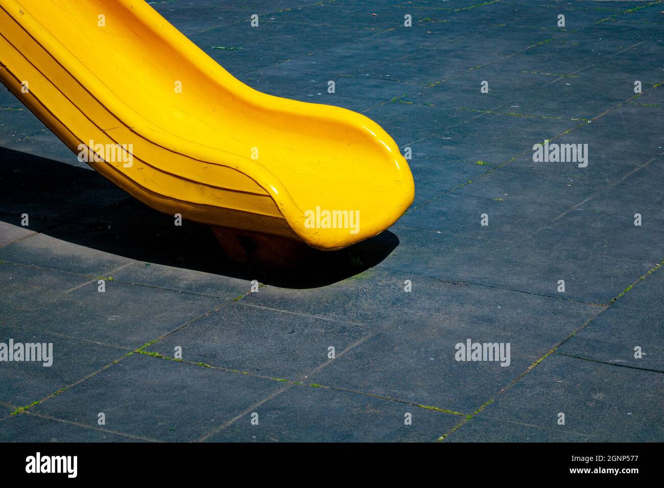 Yellow slide in the park on black background. Playground construction