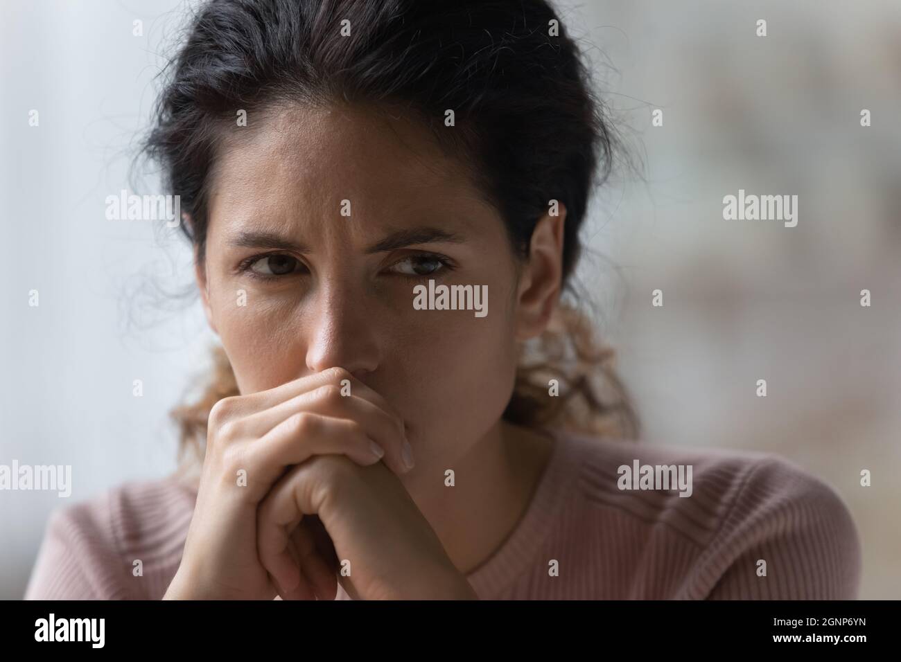 Sad young woman look in distance thinking Stock Photo
