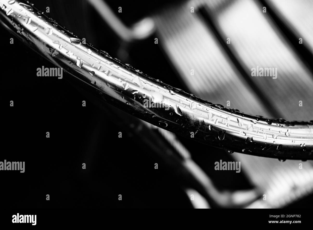 Droplets of rain on a metal chair Stock Photo