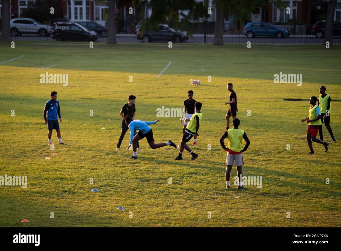 Young male footballers train in Ruskin Park a south London green space, during late afternoon, on 21st September 2021, in London, England. Stock Photo