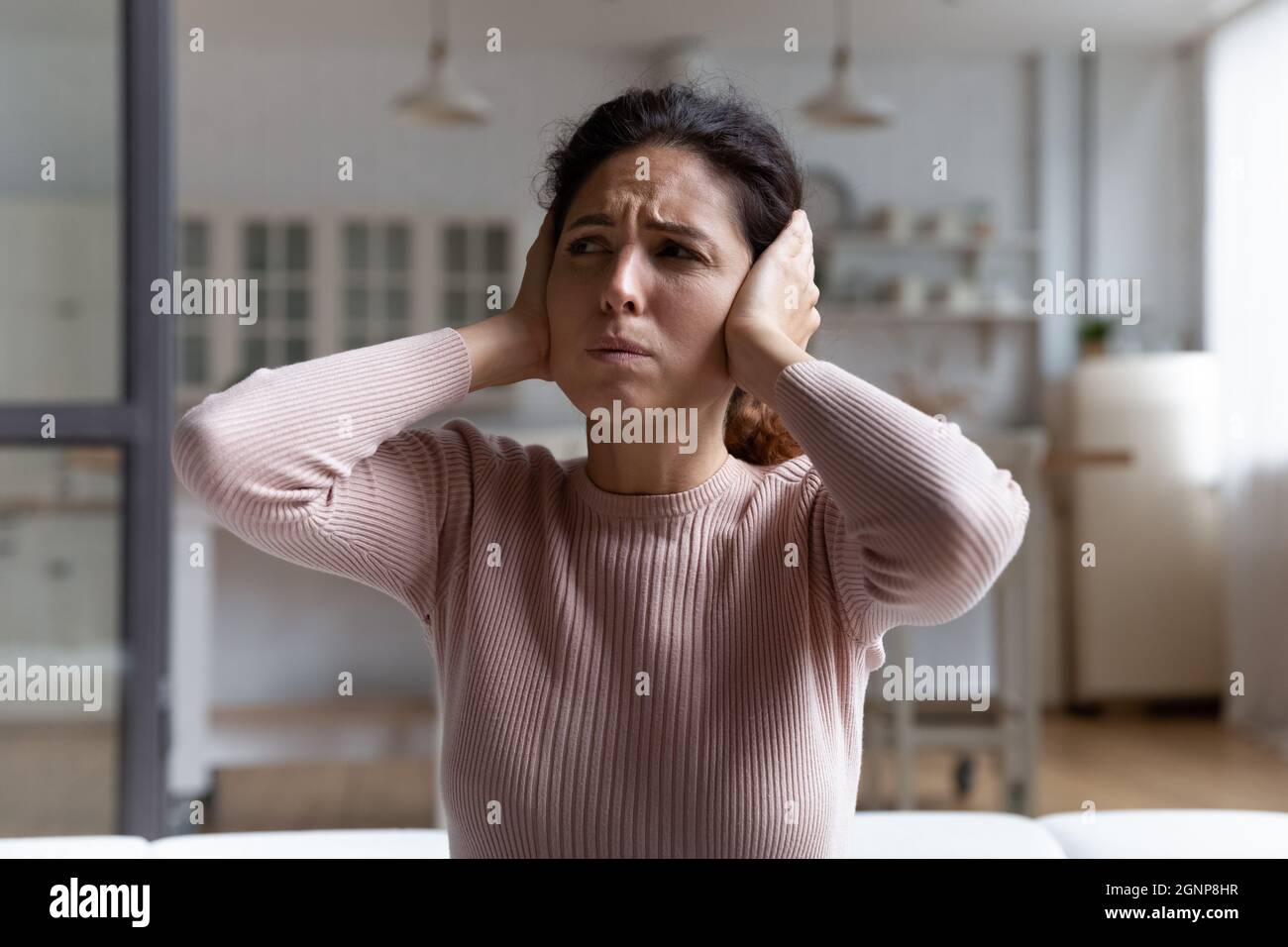 Unhappy young woman cover ears from noisy sound Stock Photo Alamy