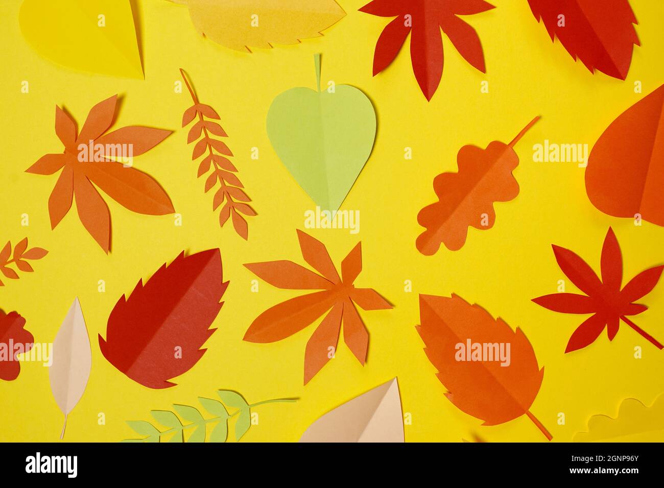 autumn paper leaves fall on yellow background. Handmade origami Stock