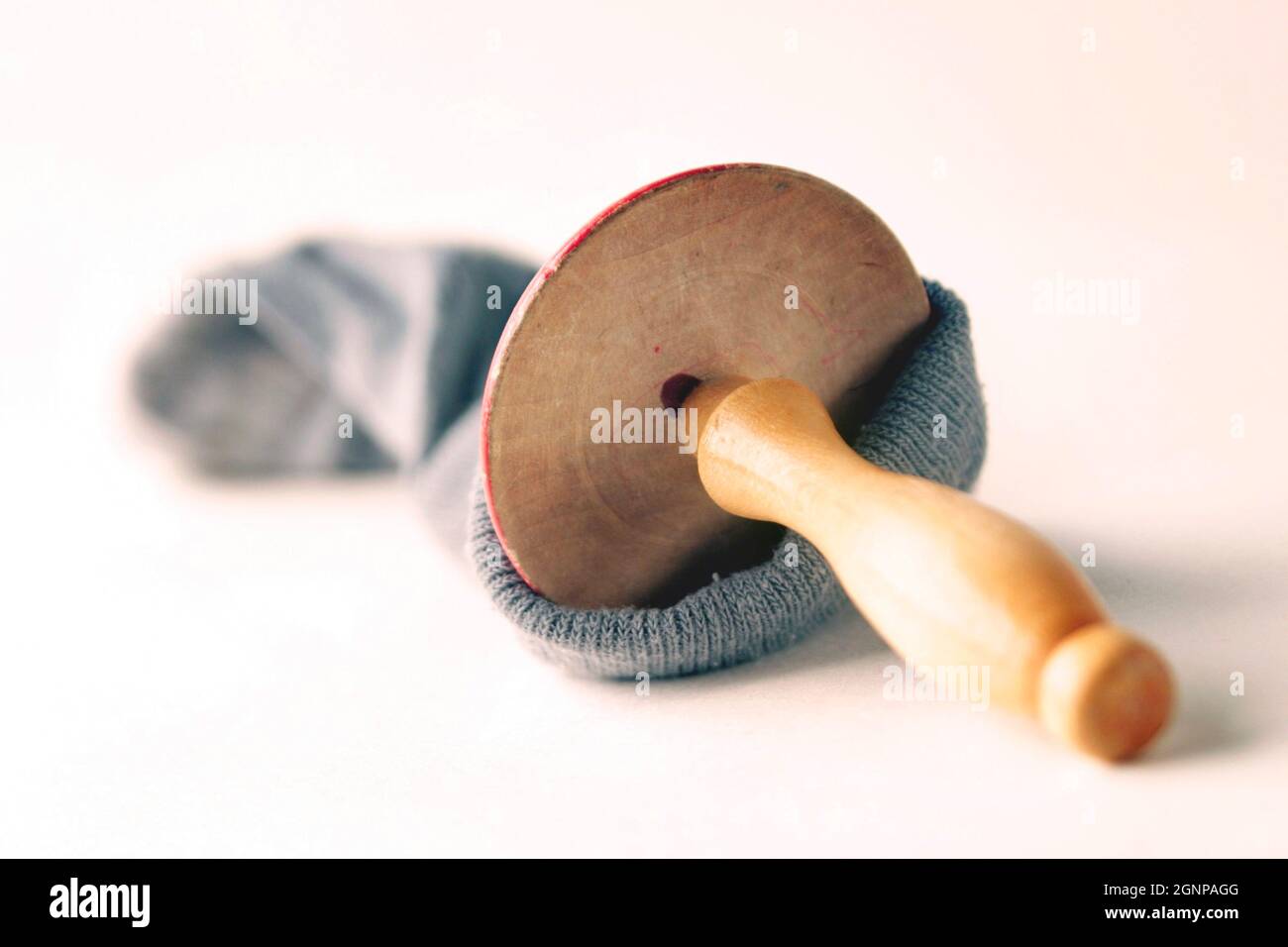 mending a sock with darning mushroom Stock Photo