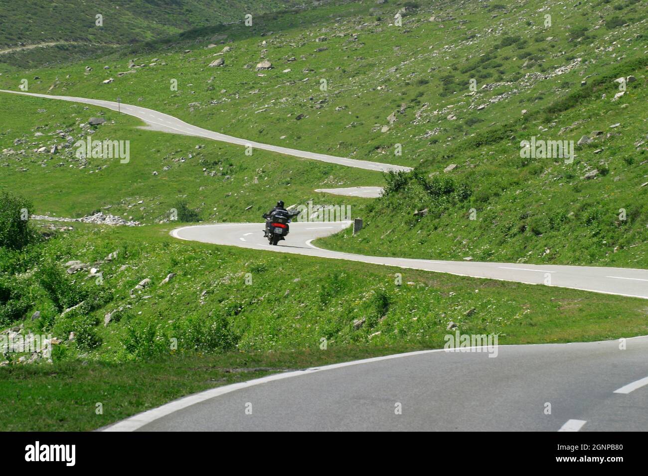 Motorcycle driver in the mountains, Austria Stock Photo
