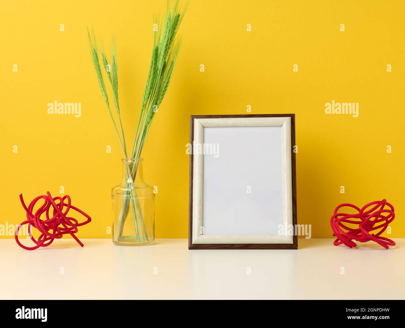 empty white wooden photo frame and green plants on white table, yellow  background Stock Photo - Alamy