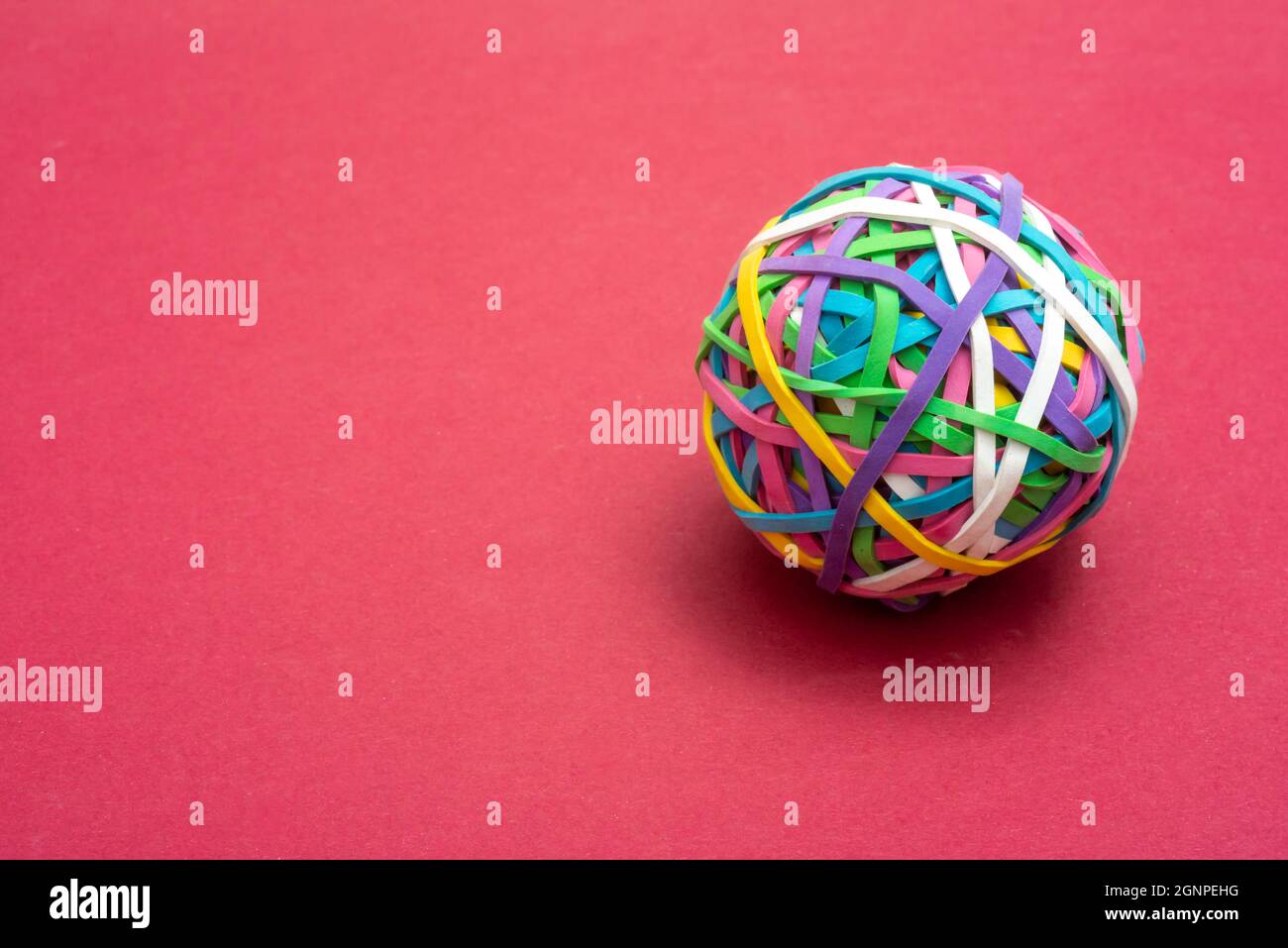 elastic or rubber bands in a ball on a pink background ,office ssupply or concept of flexibility . Stock Photo