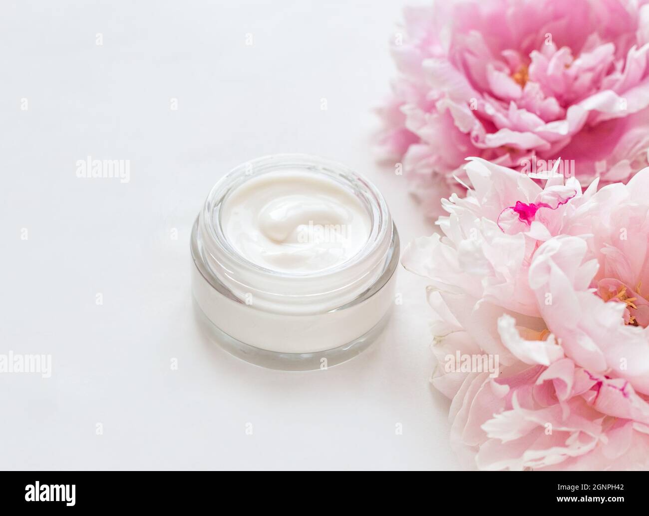 Jar of skin care cream and pink peonies Stock Photo Alamy