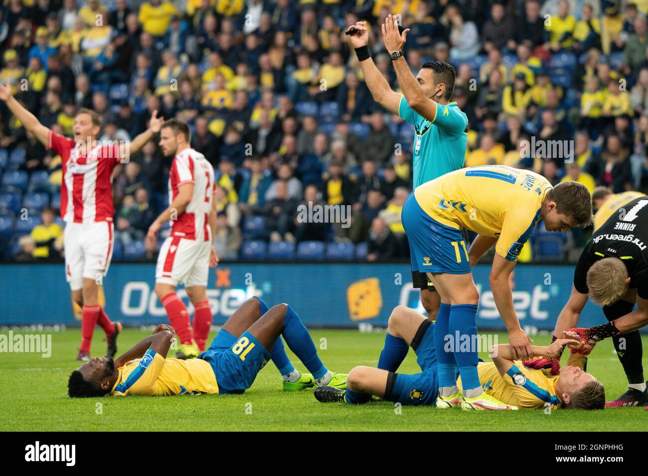 Brondby, Denmark. 26th Sep, 2021. Kevin Tshiembe (18) and Sigurd Rosted (4) of Broendby IF need treatment during the 3F Superliga match between Broendby IF and Aalborg Boldklub at Brondby Stadion. (Photo Credit: Gonzales Photo/Alamy Live News Stock Photo