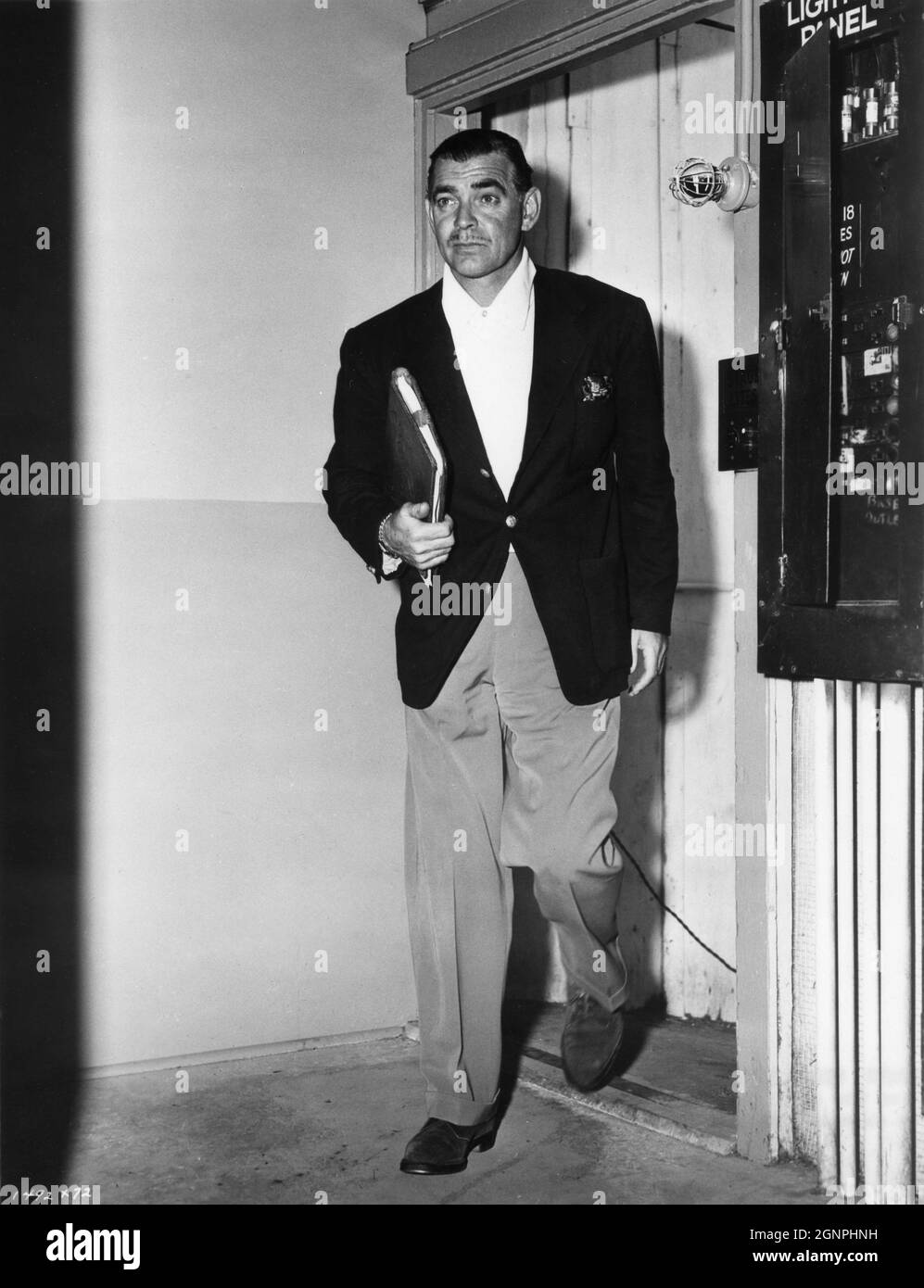 CLARK GABLE holding his leather bound script arrives on MGM Sound Stage for filming of his latest film TO PLEASE A LADY 1950 director CLARENCE BROWN story / screenplay Barré Lyndon and Marge Decker costume design Helen Rose Metro Goldwyn Mayer Stock Photo