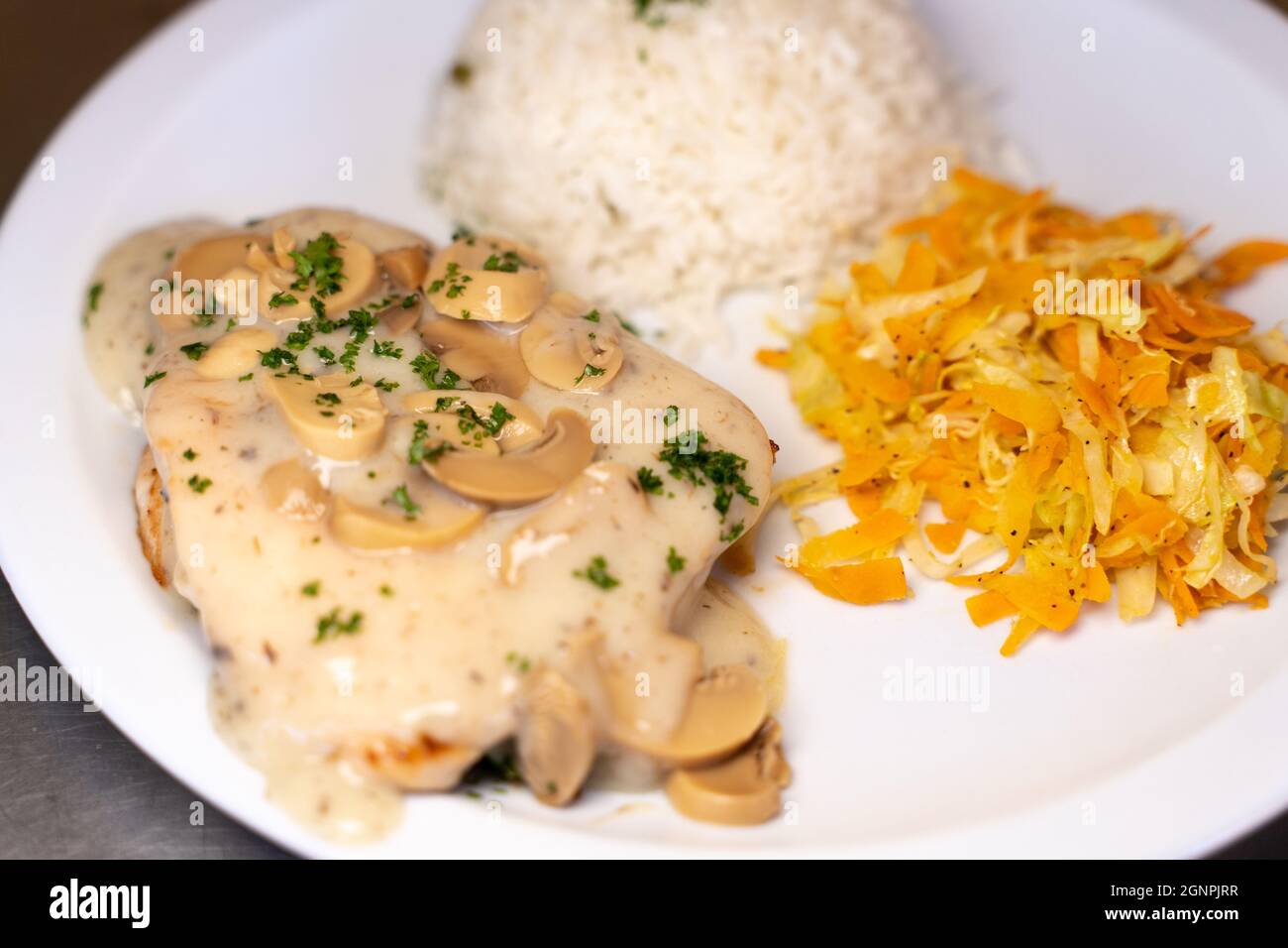 Close up photo of mixed dish of rice with meat garnished by mushroom