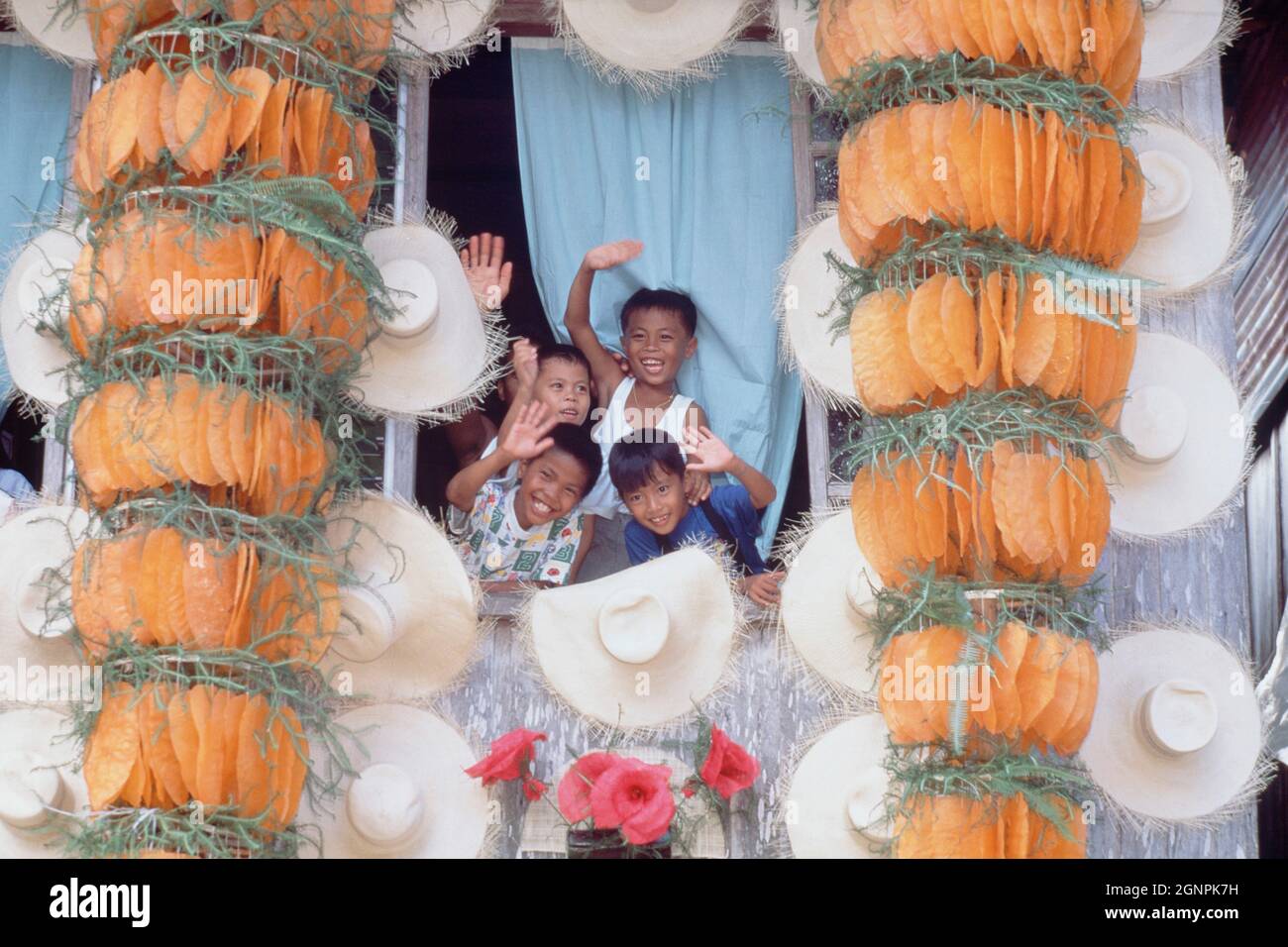 Waiving Rice Philippines. Quezon. Pahiyas rice festival. Children waiving from ...