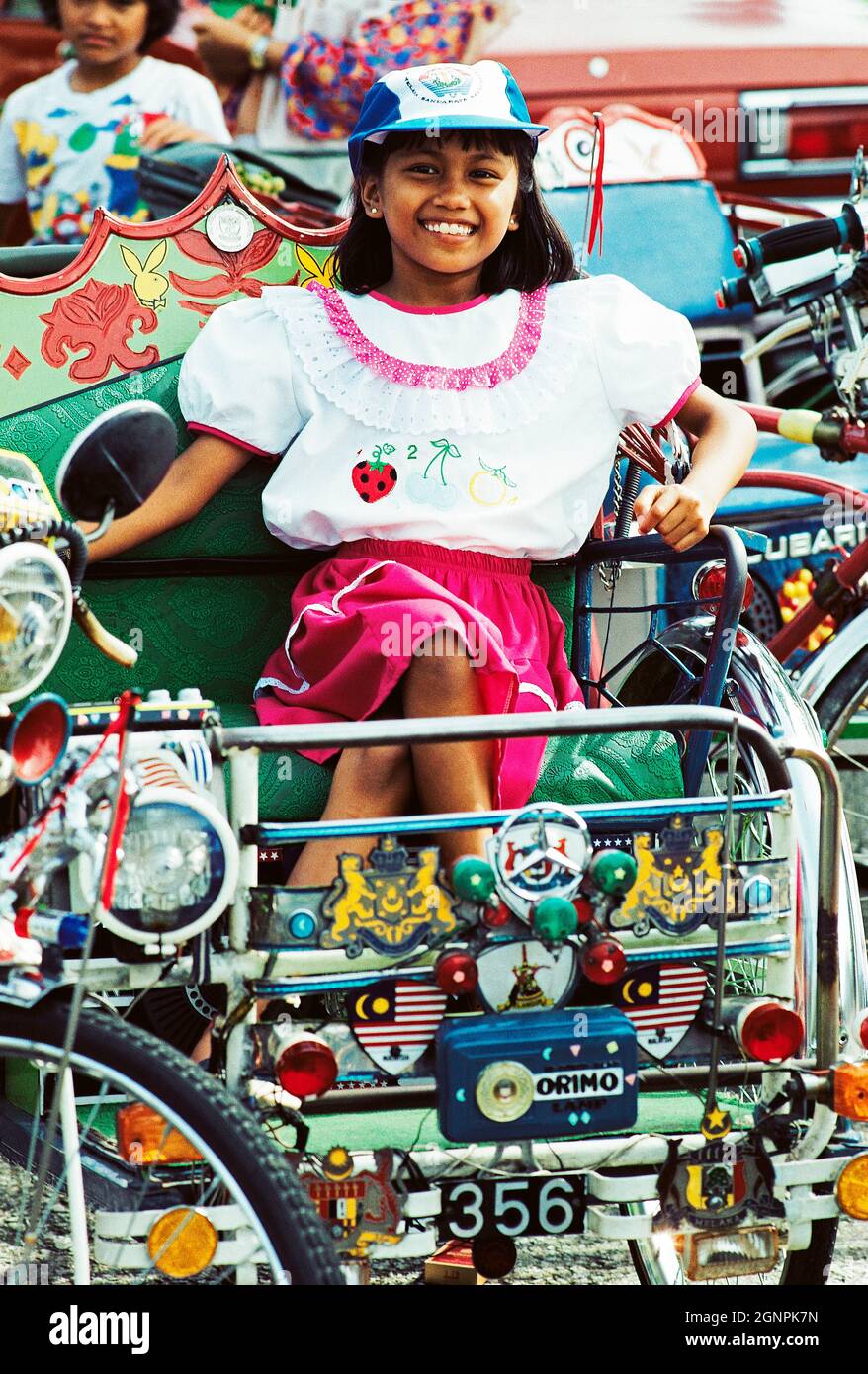 Malaysia. Malacca. Woman sitting in trishaw. Stock Photo