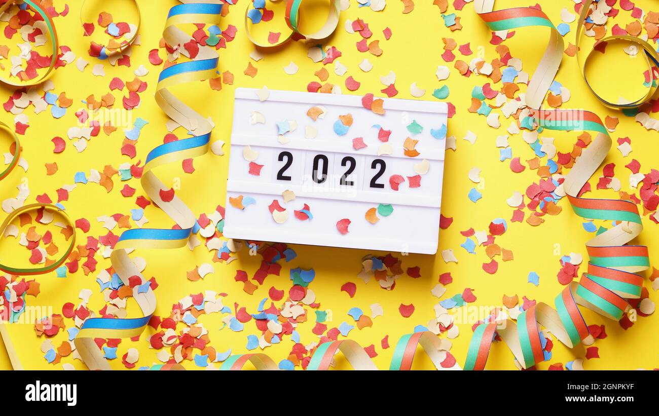 new year 2022 party celebration flat lay with confetti and streamers Stock Photo