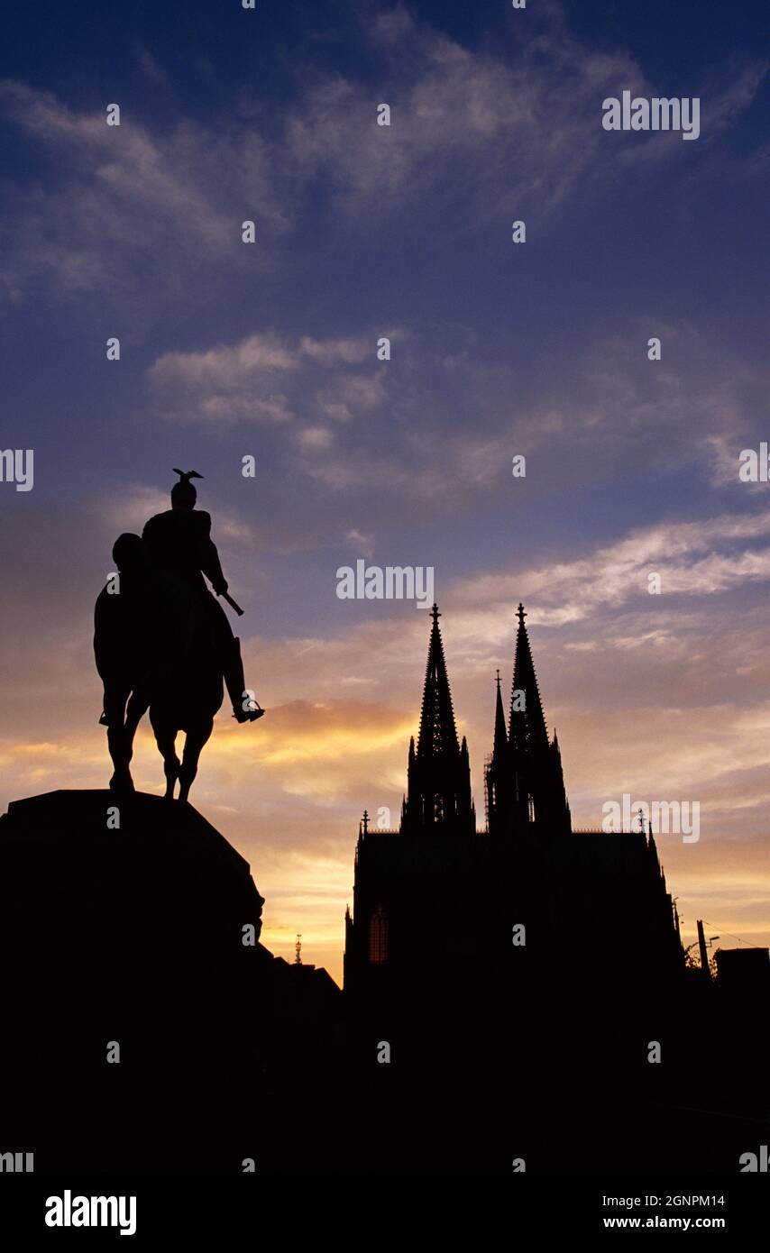 Germany. Cologne. Cathedral and Kaiser Wilhelm II equestrian statue silhouettes at sunset. Stock Photo