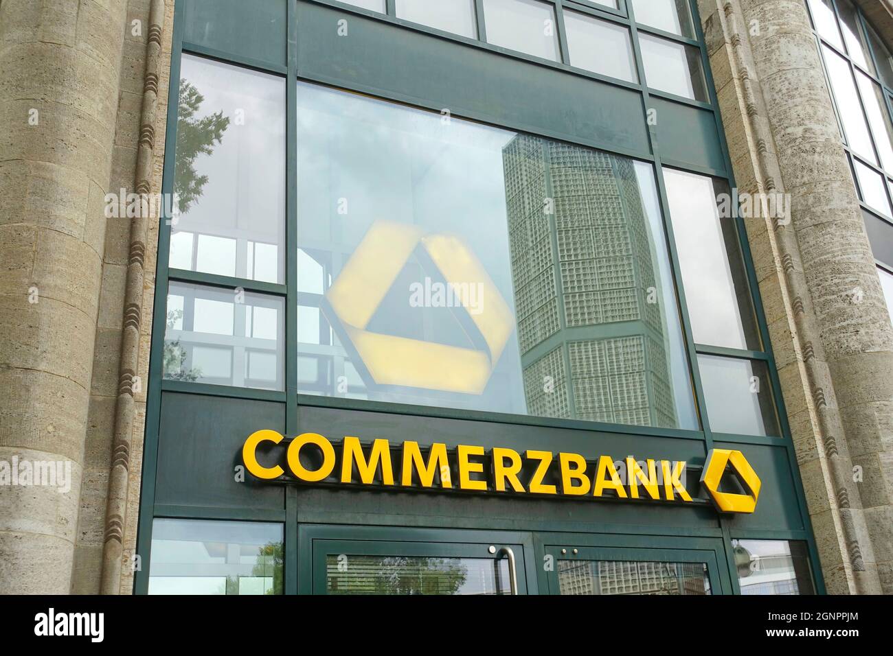 Logo of public company Commerzbank AG displayed on a smartphone. Flag of  Germany background. Credit: PIXDUCE Stock Photo - Alamy