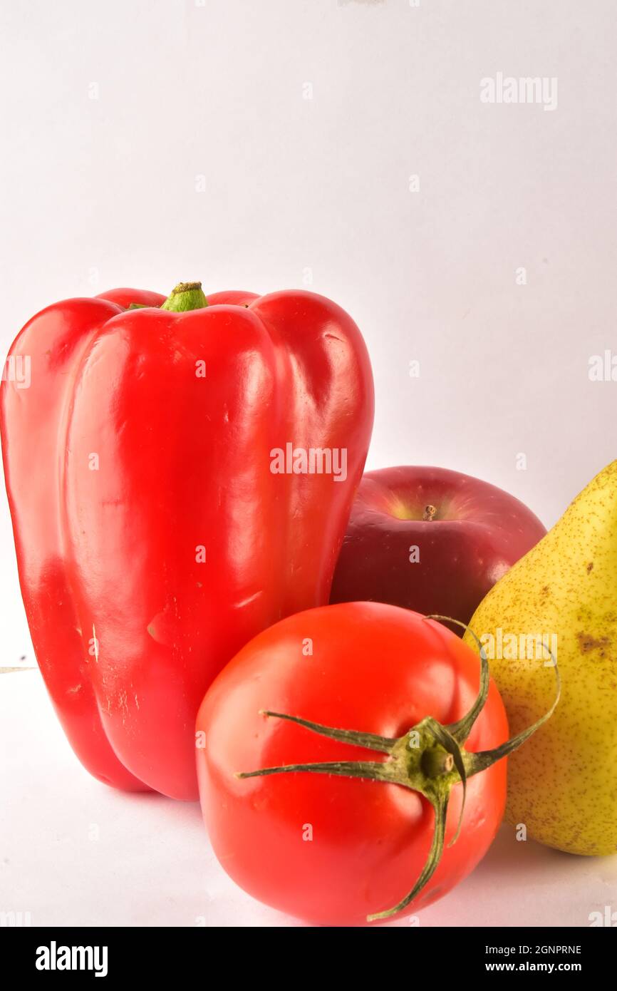 Red pepper, pear, tomato and apple on the table Stock Photo