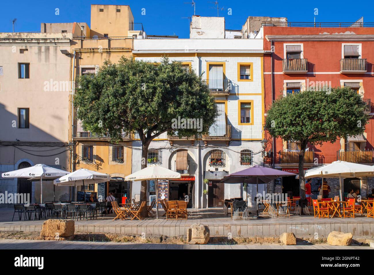 Facades of houses buildings and restaurants in Plaça del Forum Square
