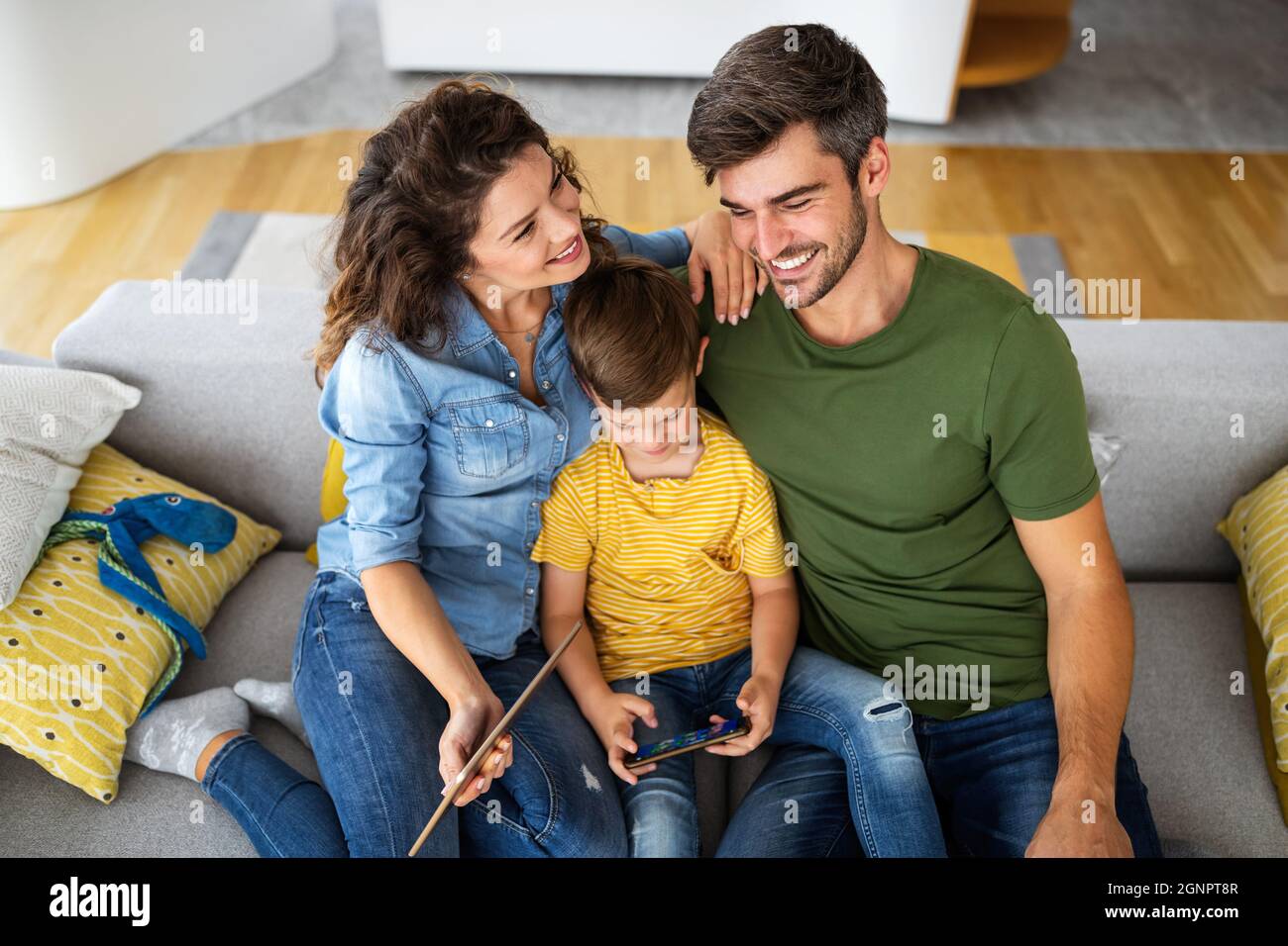 Happy modern family using computer together at home Stock Photo - Alamy