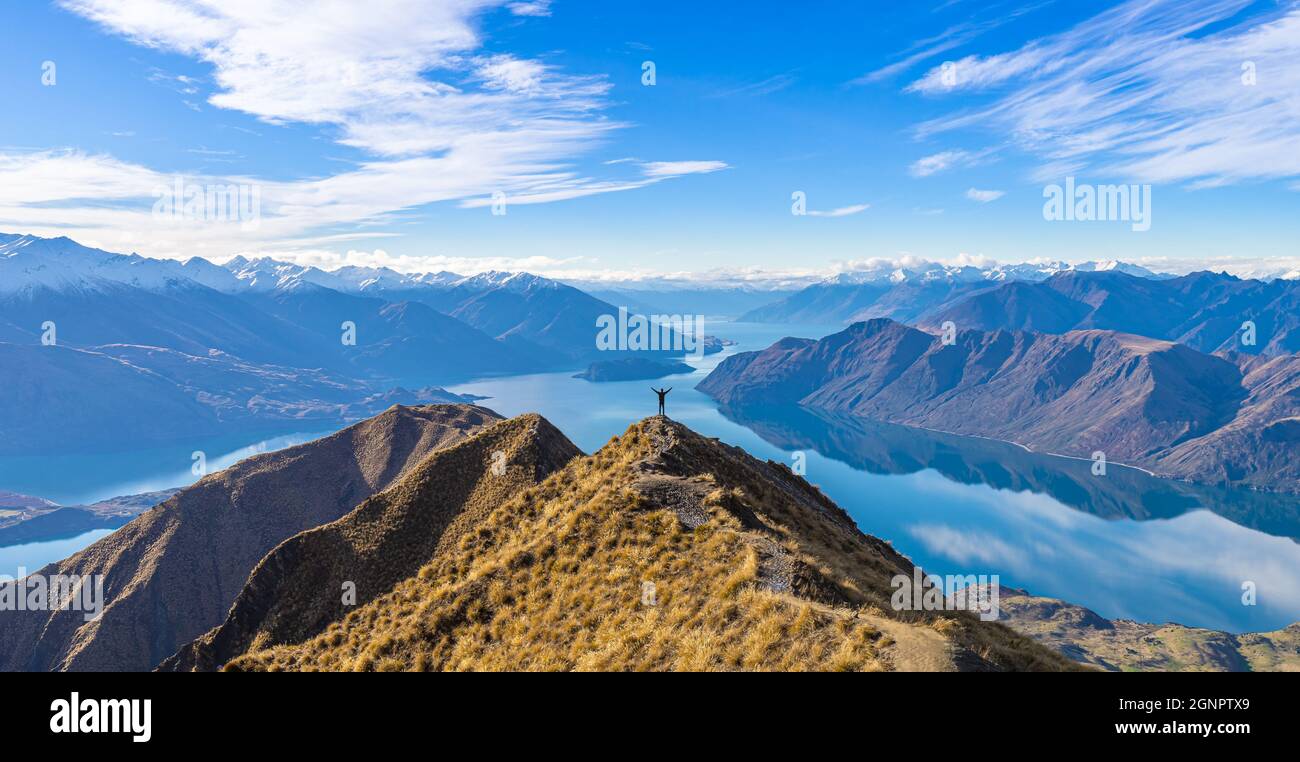 Asian traveler celebrating success at Roy's Peak Lake Wanaka New Zealand Stock Photo