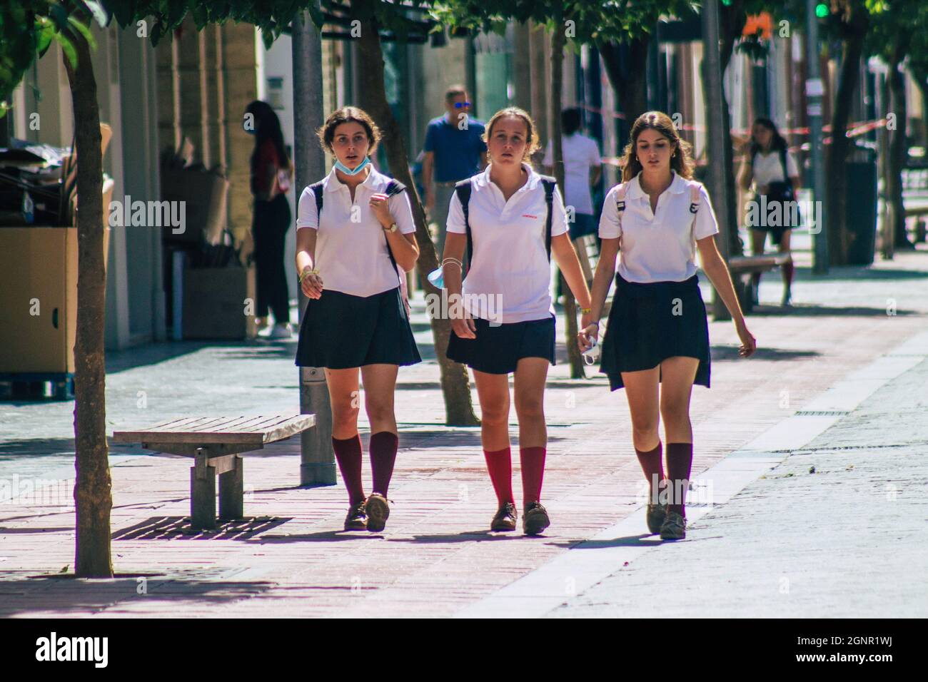 Seville Spain September 22, 2021 School girl walking in the street during  the coronavirus outbreak hitting Spain, wearing a mask is not mandatory but  Stock Photo - Alamy
