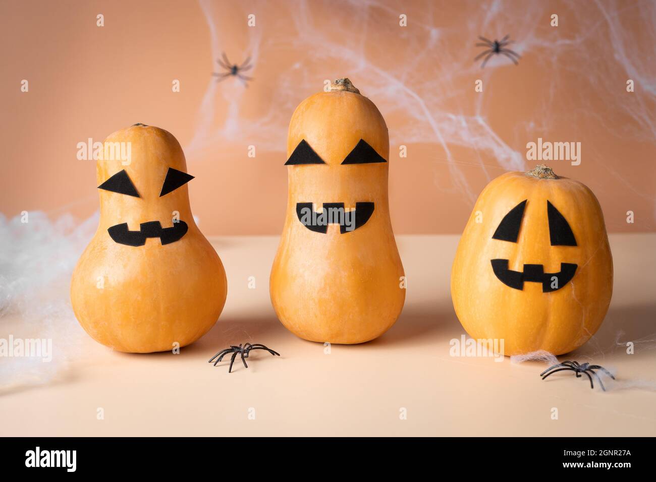 Halloween pumpkins with scary faces on an orange background Stock Photo ...