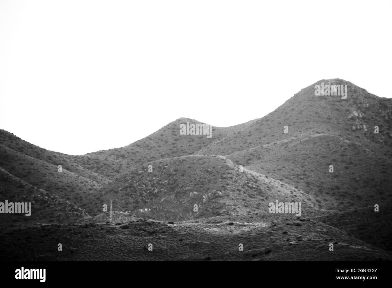 Clear morning sky with silhouettes of mountains in Spain. Monochrome picture. Stock Photo