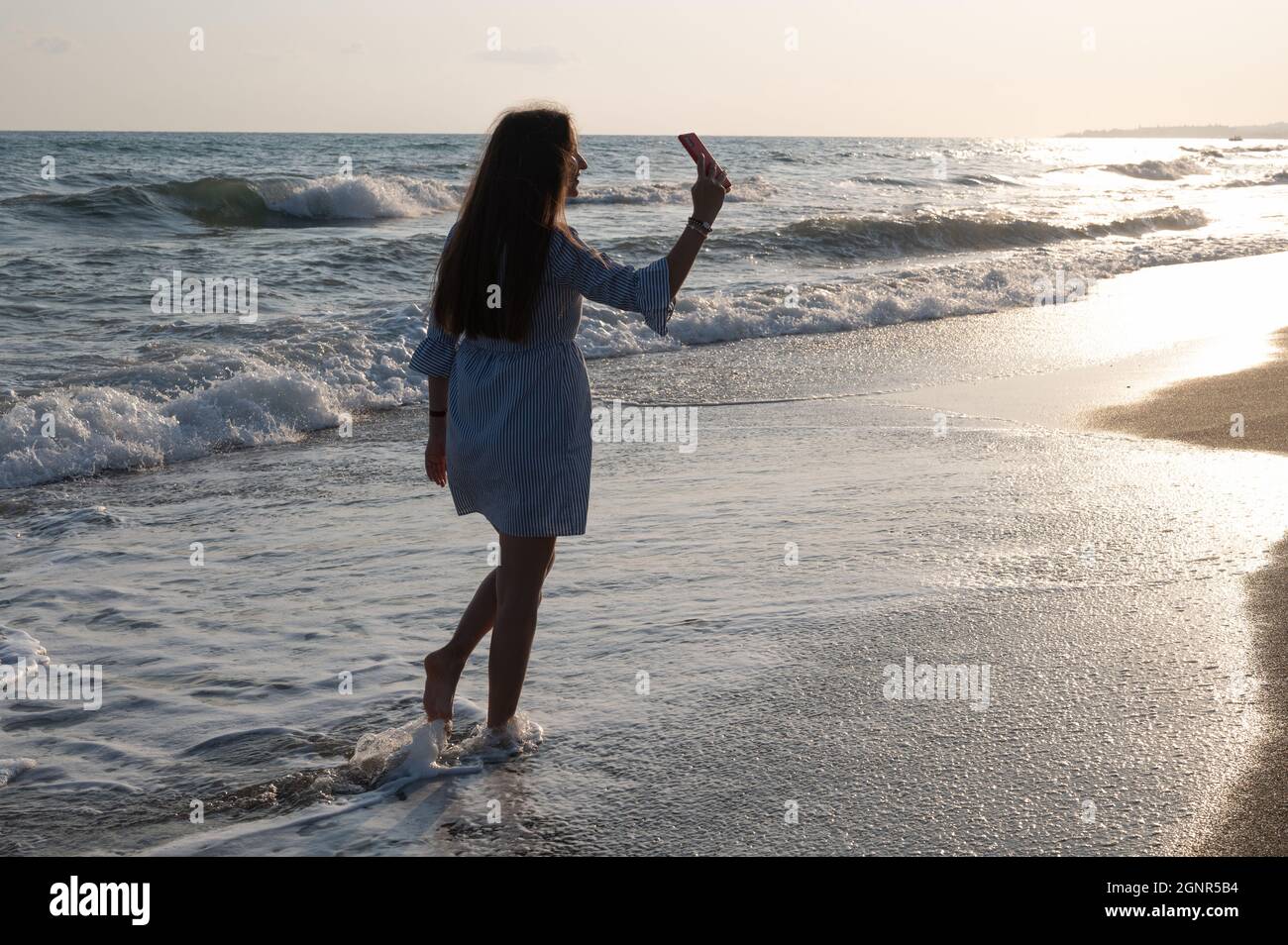 Pretty Young Girl Standing In Sea. Back Side To Camera Stock Photo, Picture  and Royalty Free Image. Image 5712697.