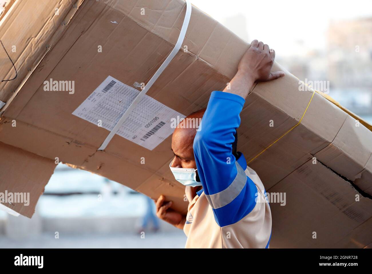 Worker man carrying cardboard boxes on the street. Dubai. United Arab Emirates Stock Photo Alamy