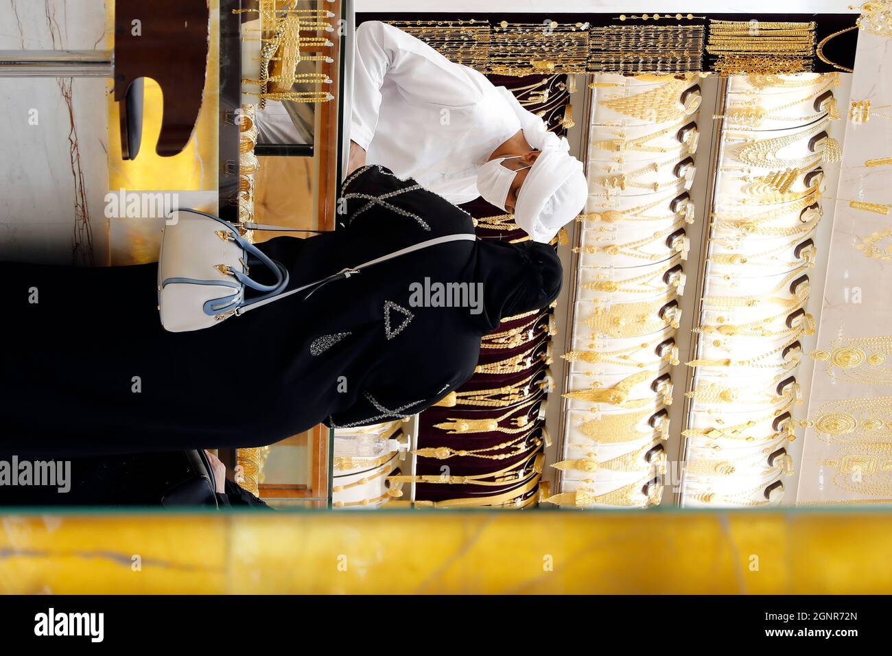 Emirati woman  inside a jewellers in the Gold Souk in the district of Deira.  Dubai. United Arab Emirates. Stock Photo