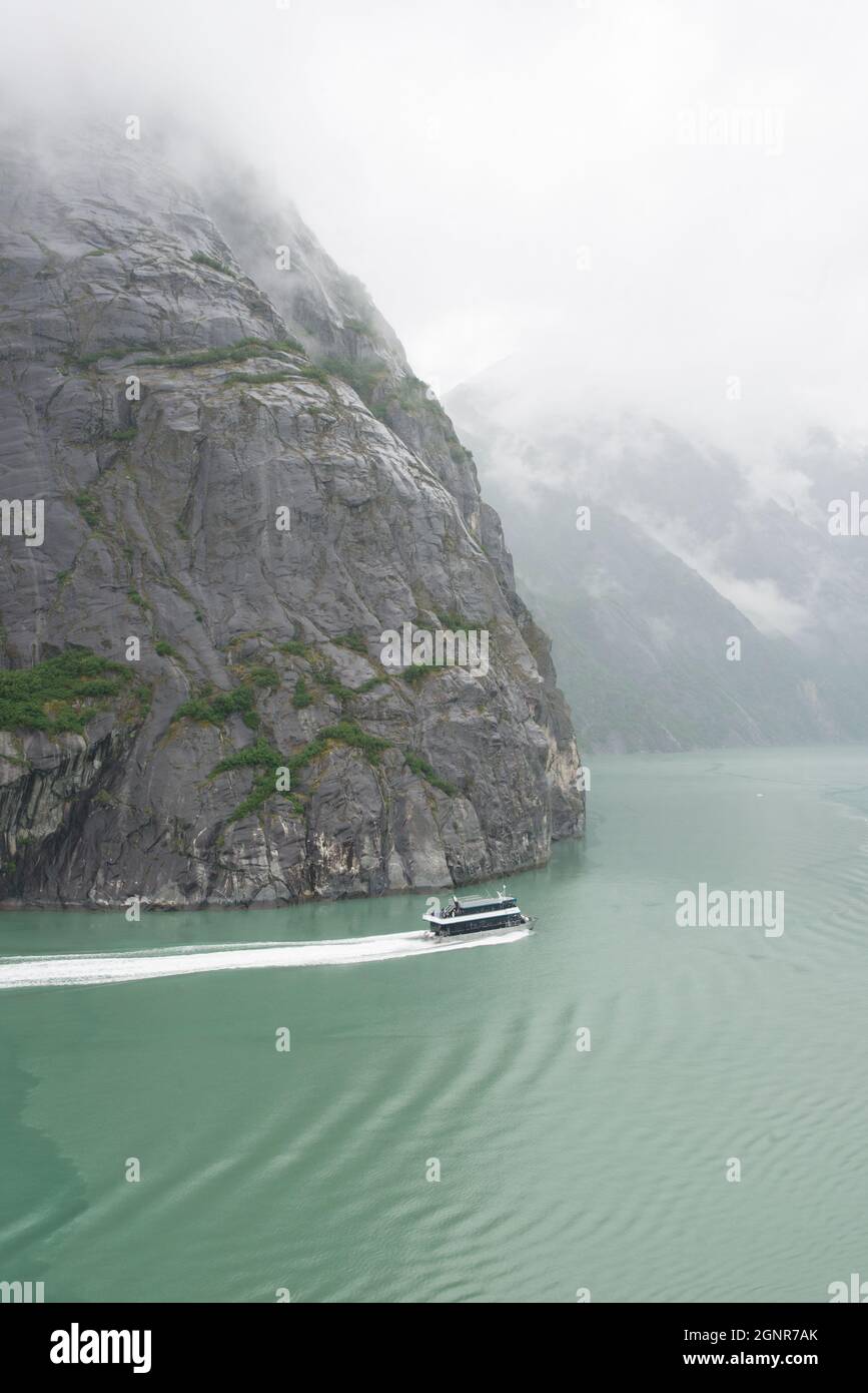 A sight-seeing boat give perspective as moves through Tracy Arm-Fords Terror Wilderness in Alaska. Stock Photo