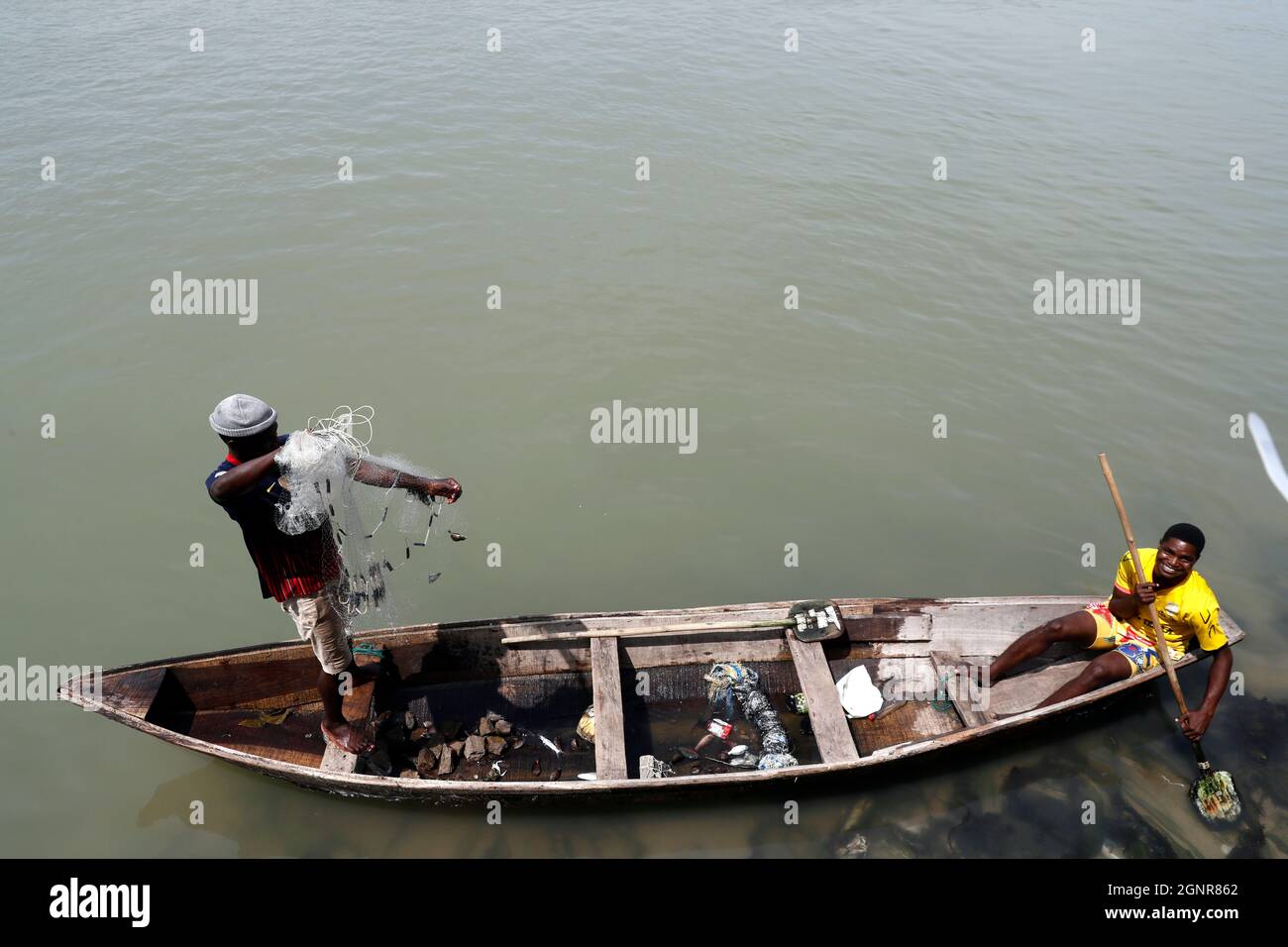 African fisherman throwing net into the river in traditional way.  Benin. Stock Photo