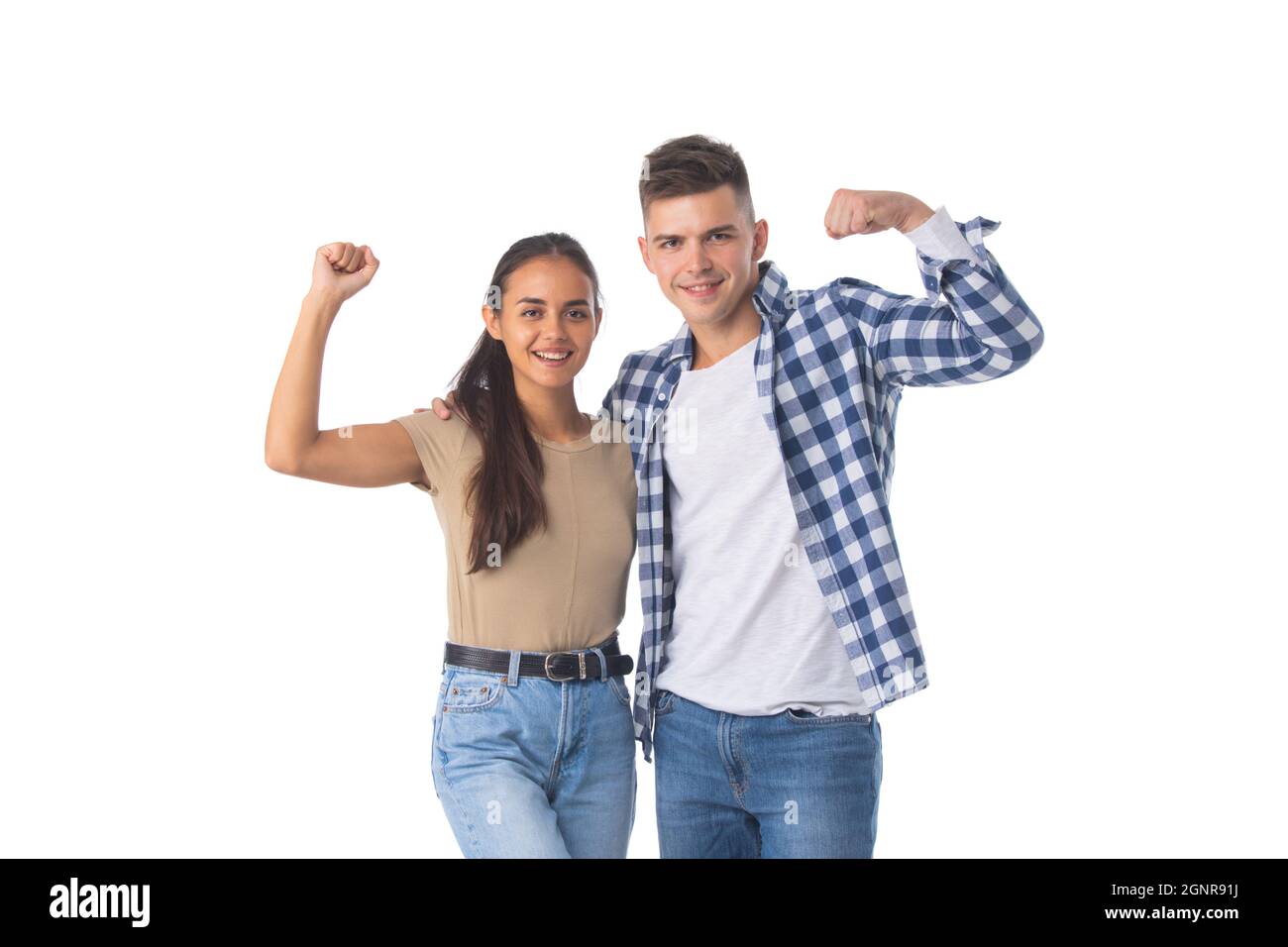 Portrait of a young attractive couple standing isolated over white background, flexing biceps Stock Photo
