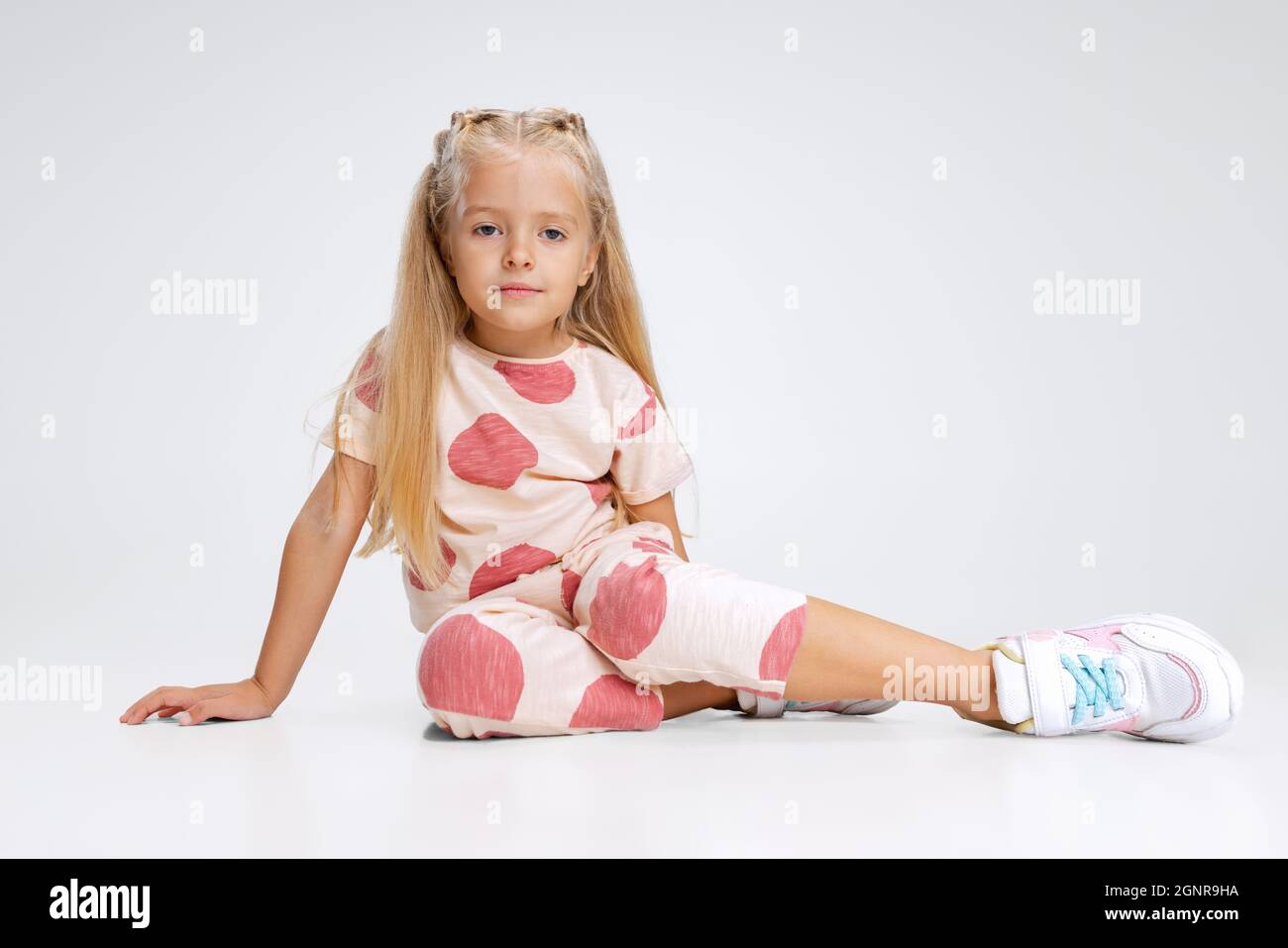 Fulllength portrait of little Caucasian girl, child posing isolated over white studio