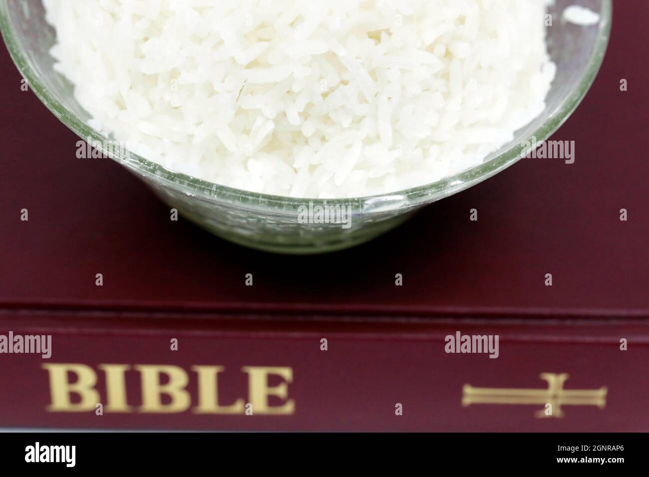 Bowl of rice and Bible during Lent. A solemn religious observance that