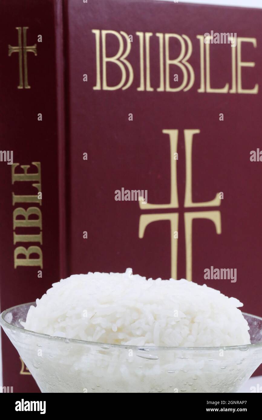 Bowl of rice and Bible during Lent. A solemn religious observance that