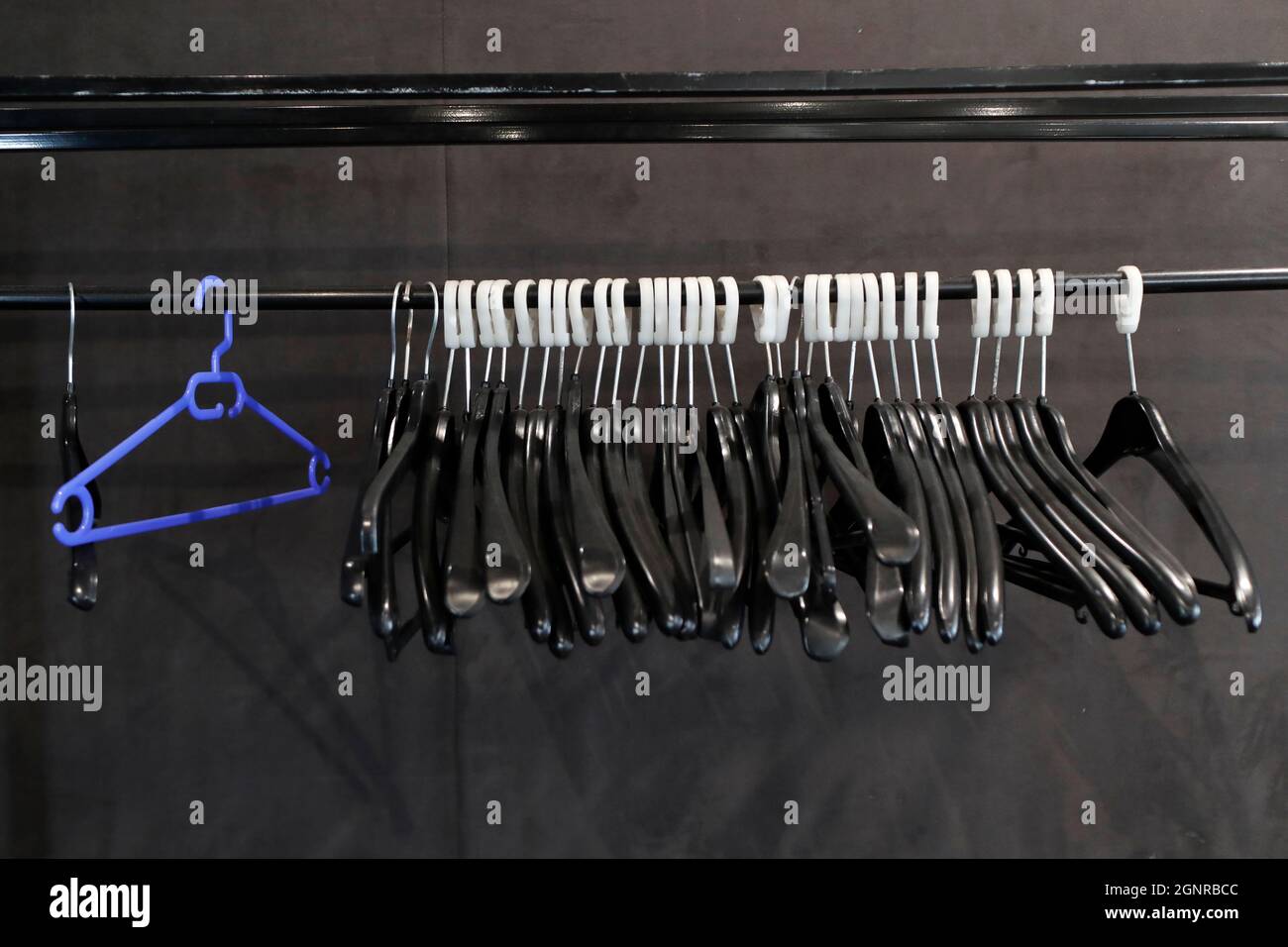 A row of empty red coat hangers.  France. Stock Photo