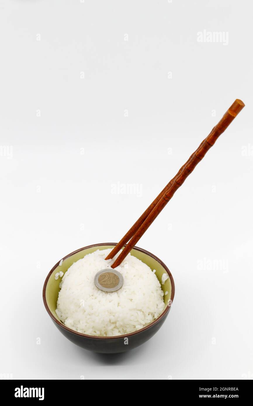Money and food concept. Coin on a bowl of steamed white rice Stock ...