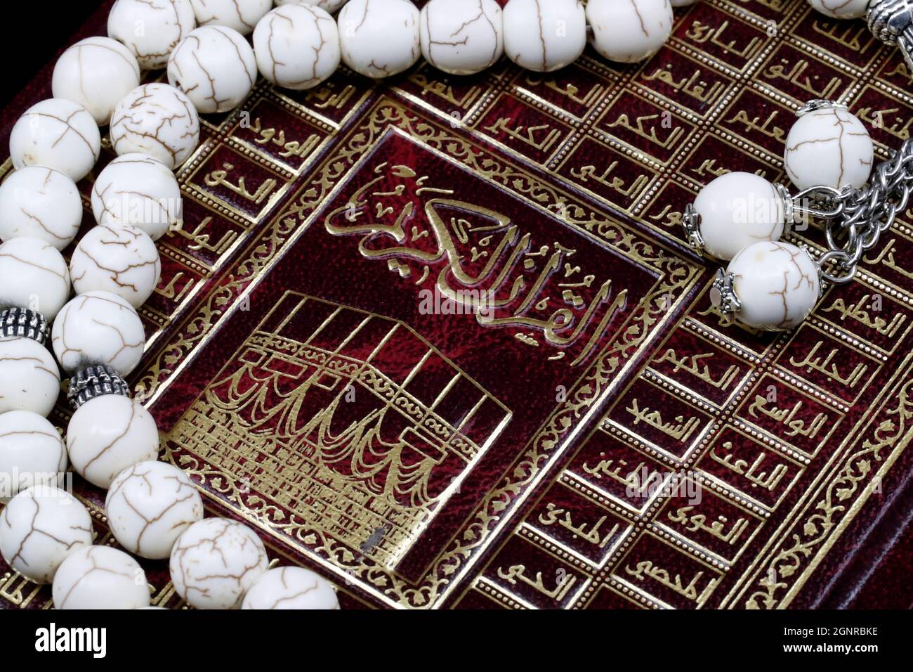 Cover of the Holy Quran and Tasbih ( muslim prayer beads ). Faith anbd religion. 99 Names of