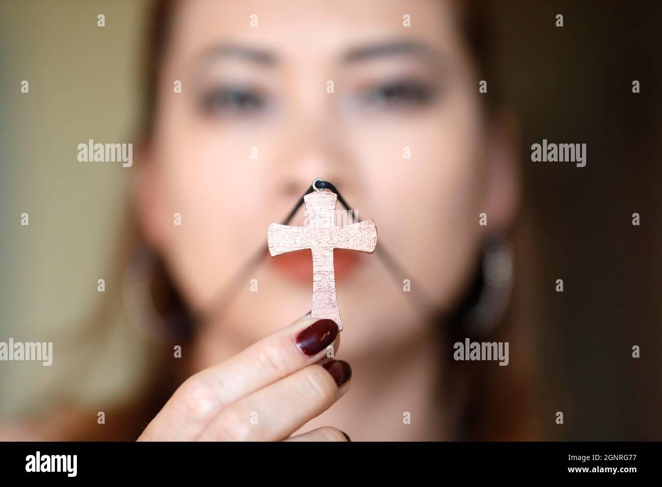 Christian woman wearing woodene cross pendant necklace Stock Photo Alamy