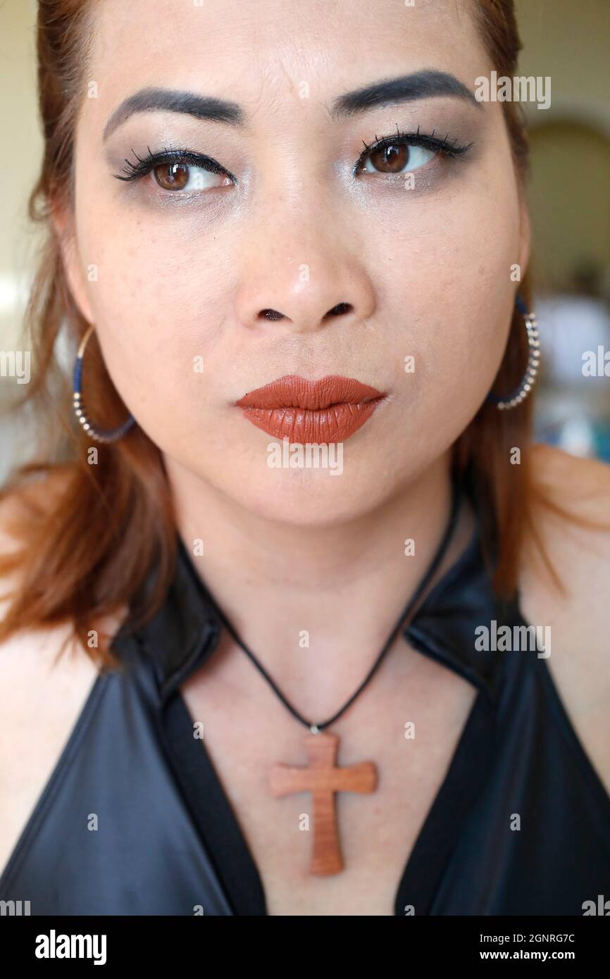 Christian woman wearing woodene cross pendant necklace Stock Photo Alamy