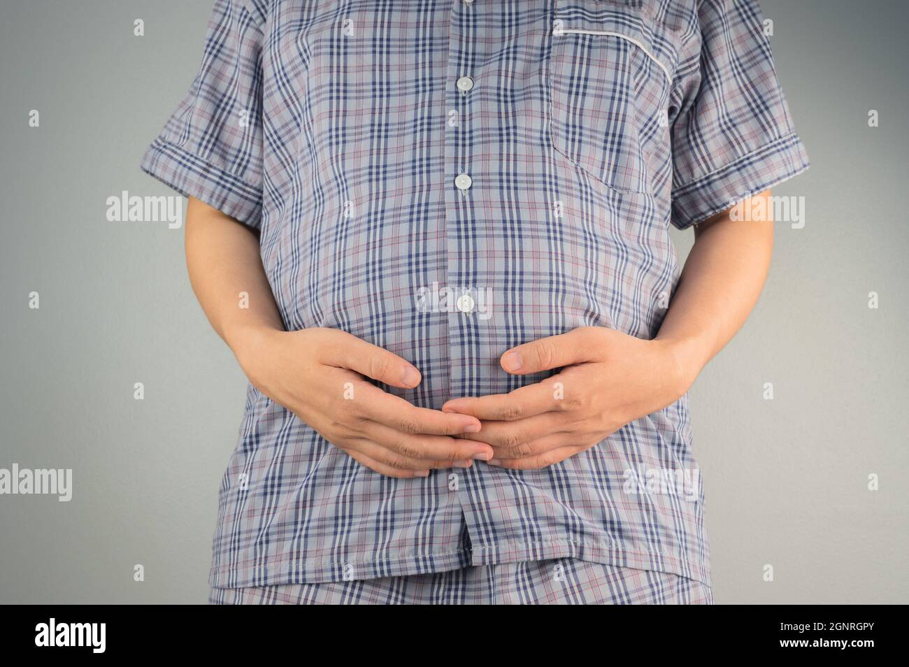 pregnant woman holding her stomach Stock Photo - Alamy