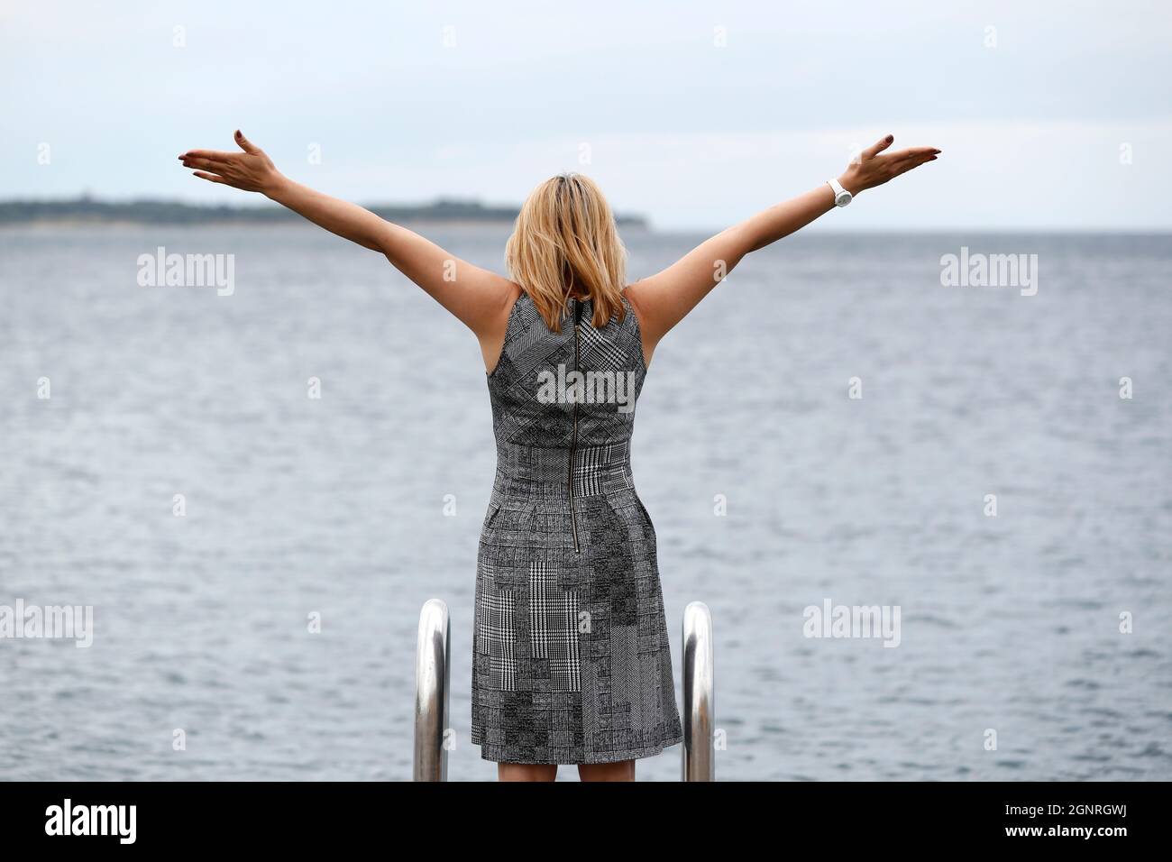 Woman standing sea raised arms hi-res stock photography and images - Alamy