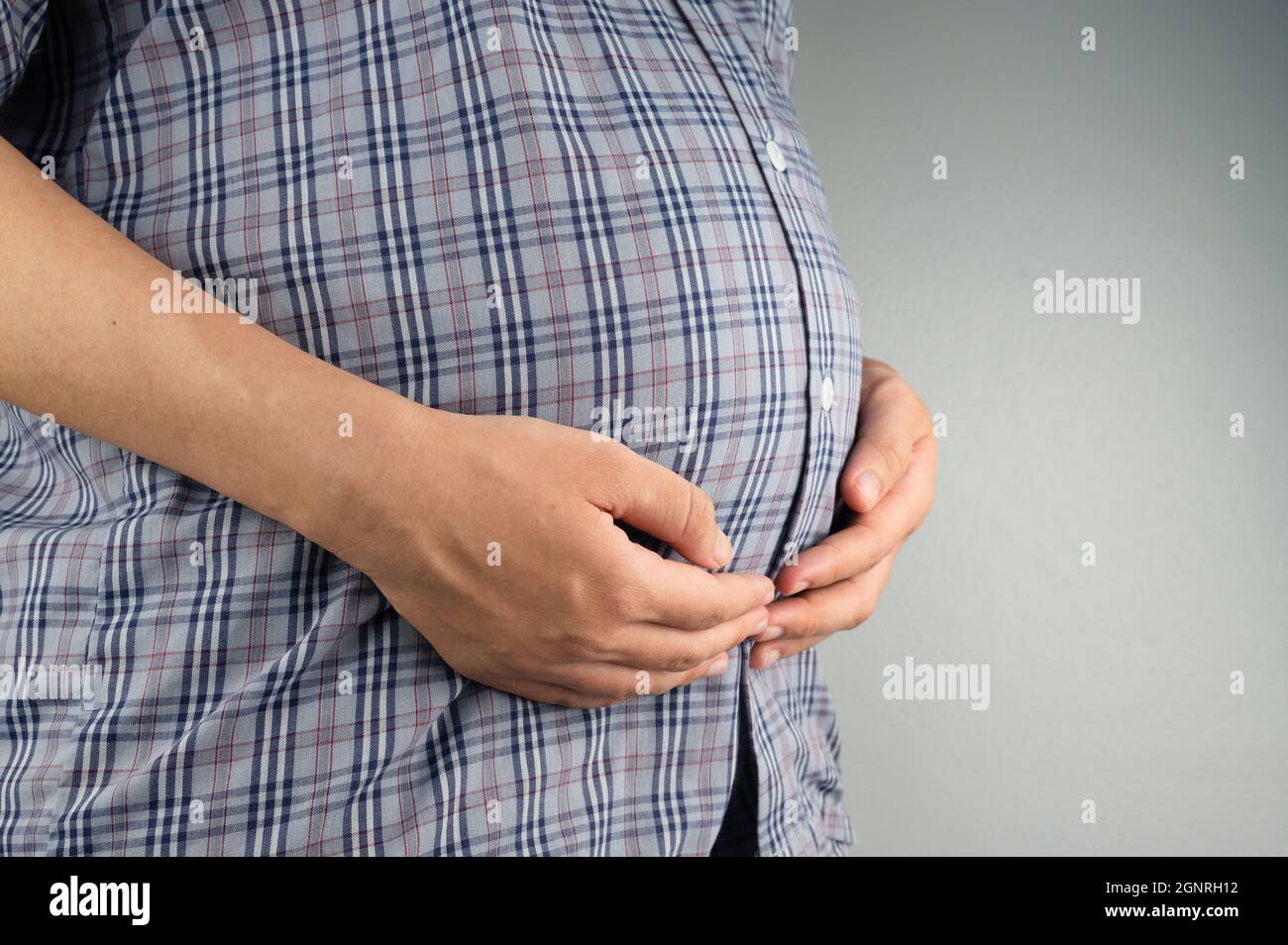pregnant woman holding her stomach Stock Photo - Alamy